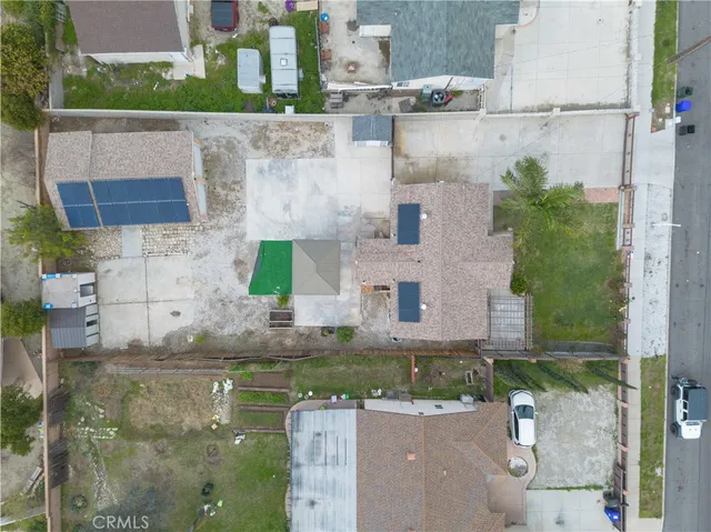 an aerial view of a house with a yard