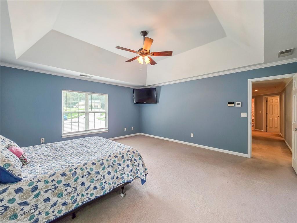 43 Ivy Mist Lane Acworth, GA 30101 - Photo 21 of 58 a bedroom with a bed and a chandelier
