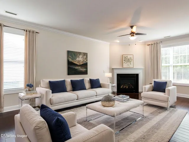 an empty room with windows and painting on the wall