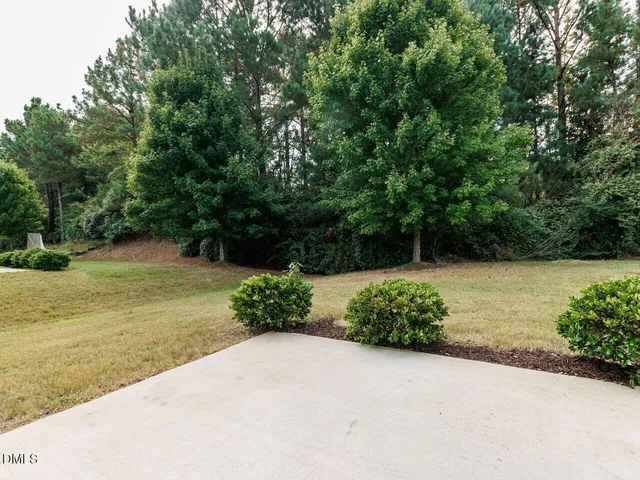 an empty room with fan and windows