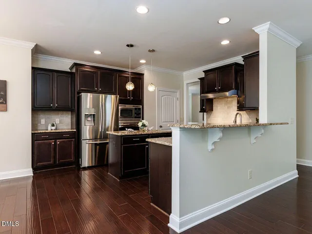 a kitchen with stainless steel appliances a refrigerator stove and microwave
