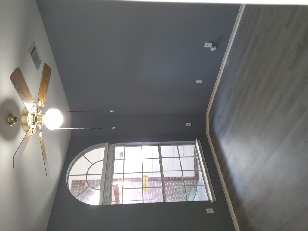 2018 Old Mill Road Cedar Park, TX 78613 - Photo 12 of 22 an empty room with wooden floor chandelier fan and windows