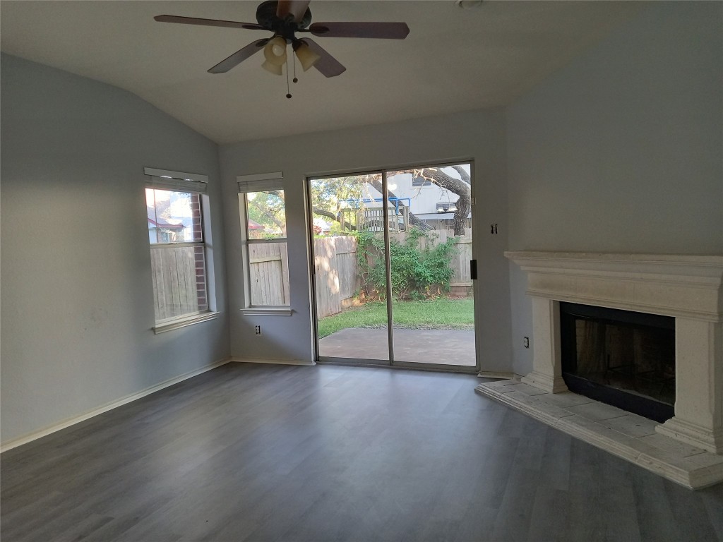 2018 Old Mill Road Cedar Park, TX 78613 - Photo 17 of 22 a view of empty room with wooden floor and fireplace