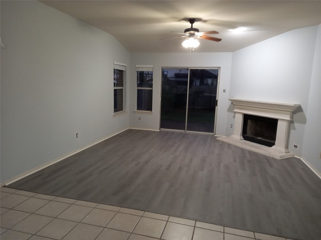 2018 Old Mill Road Cedar Park, TX 78613 - Photo 2 of 22 a view of a livingroom with a fireplace a ceiling fan and window