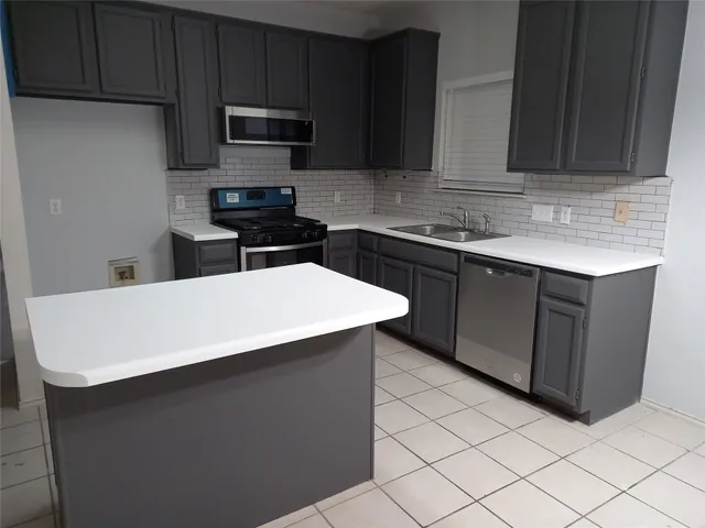 a bathroom with a glass door shower a sink and vanity