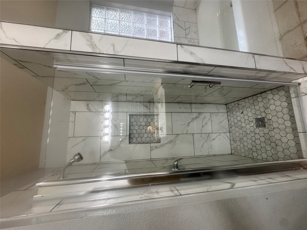 2018 Old Mill Road Cedar Park, TX 78613 - Photo 22 of 22 a bathroom with a glass door shower a sink and vanity