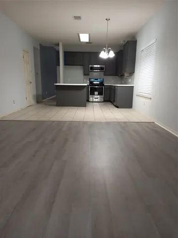 a view of a dining hall with couches and chandelier