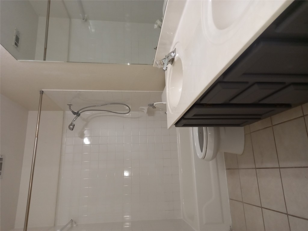 2018 Old Mill Road Cedar Park, TX 78613 - Photo 4 of 22 a bathroom with a granite countertop sink a toilet and shower