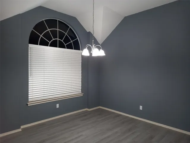 a view of front door with wooden floor and windows