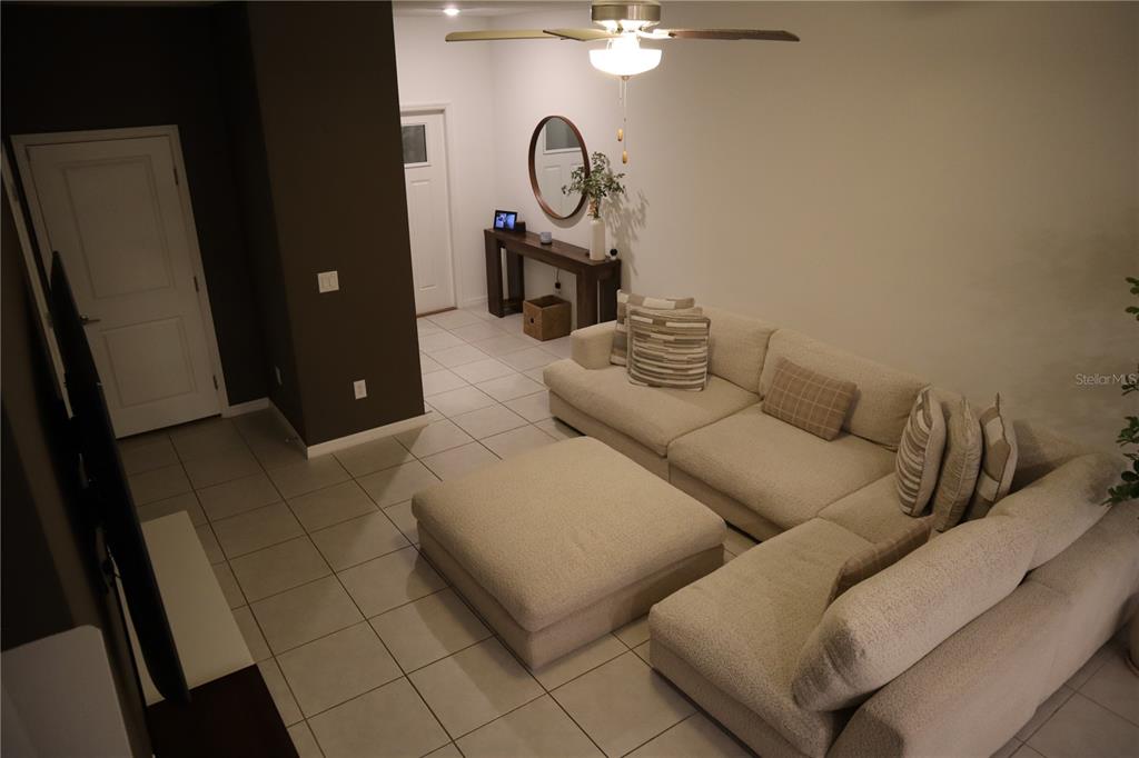 8339 Birch Hvn Lane New Port Richey, FL 34655 - Photo 3 of 16 a living room with furniture a mirror and white walls