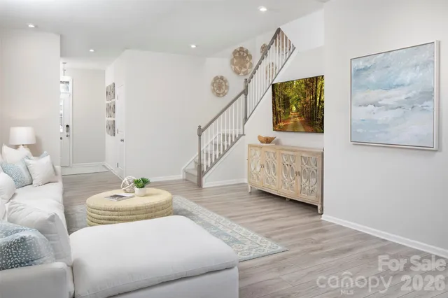 a living room with furniture and wooden floor