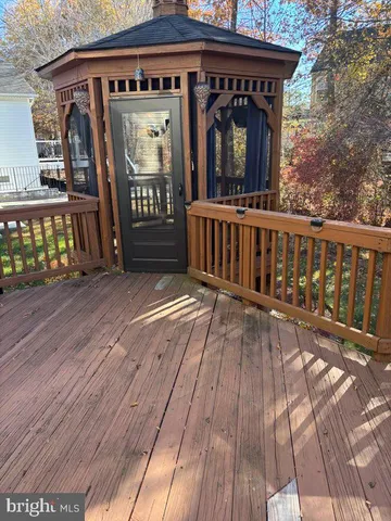 a view of a wooden deck with a yard