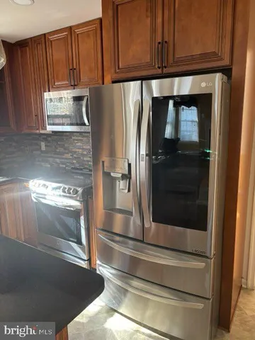 a kitchen with a refrigerator and cabinets