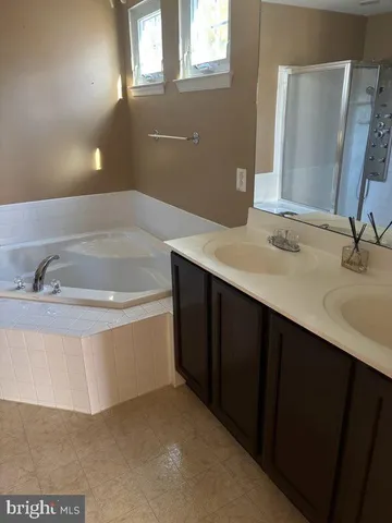 a bathroom with a double vanity sink and mirror