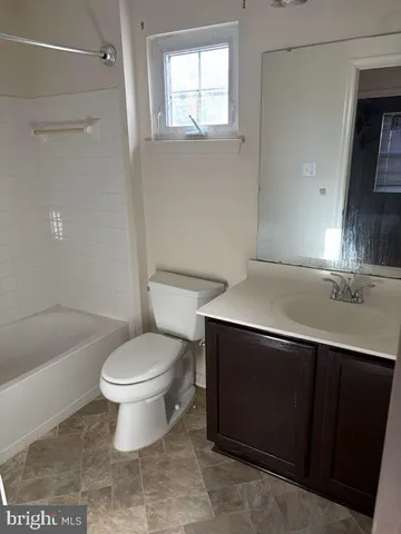 a bathroom with a sink toilet vanity and bathtub