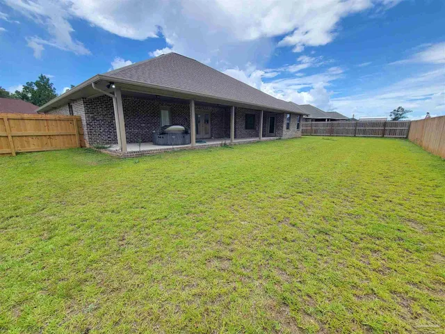 a view of a house with backyard porch and garden