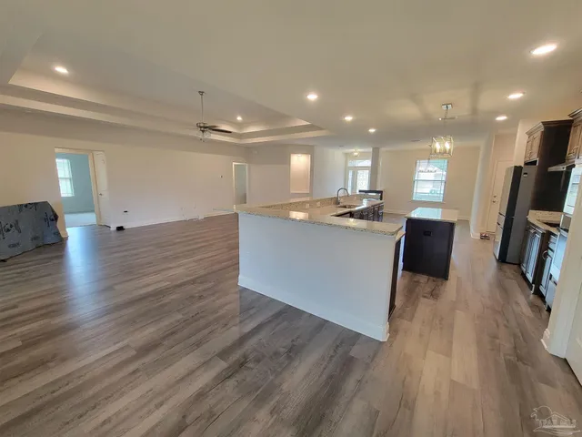 a view of kitchen with cabinets and wooden floor