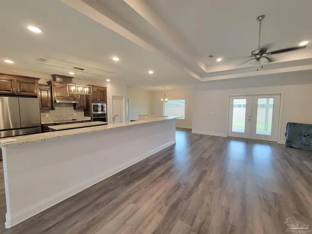 a view of a kitchen with a sink and wooden floor