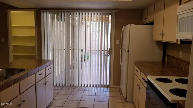 a view of a livingroom with a chandelier fan
