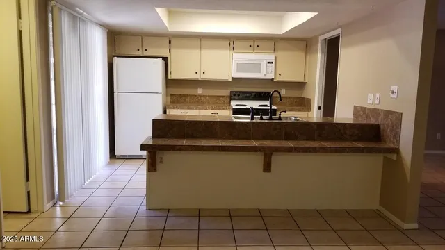 a kitchen with stainless steel appliances a refrigerator sink and cabinets