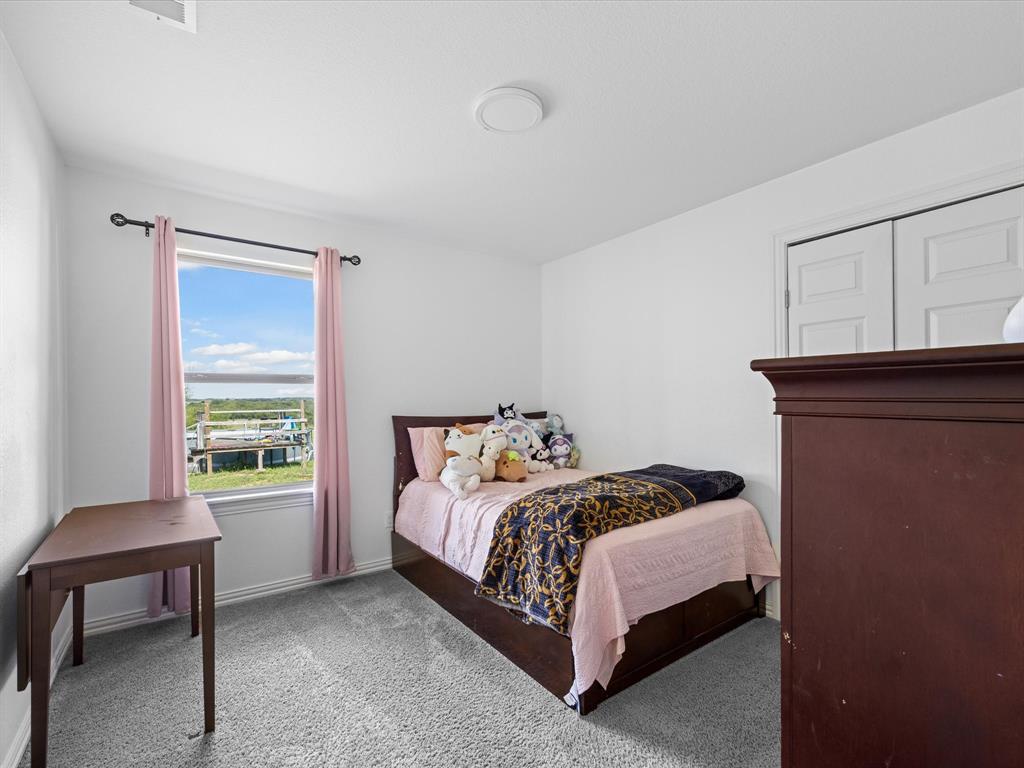 781 Alsdorf Road Ennis, TX 75119 - Photo 18 of 39 a bedroom with a bed and a window