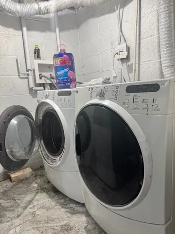 a utility room with sink dryer and washer