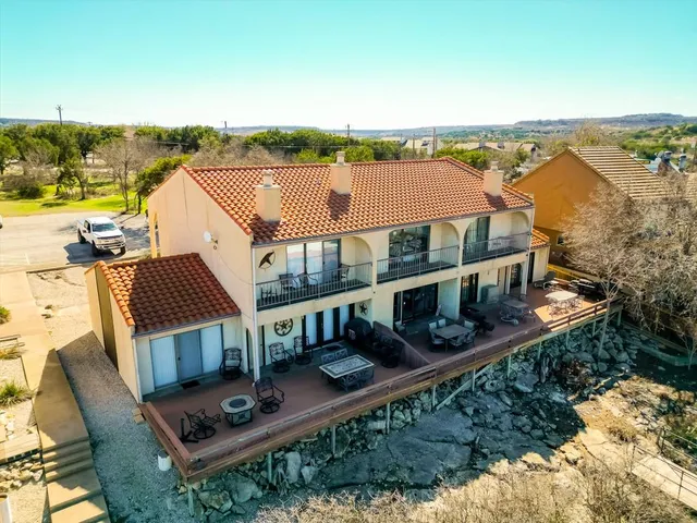 an aerial view of a house with balcony and outdoor space