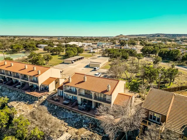 an aerial view of a house with a yard