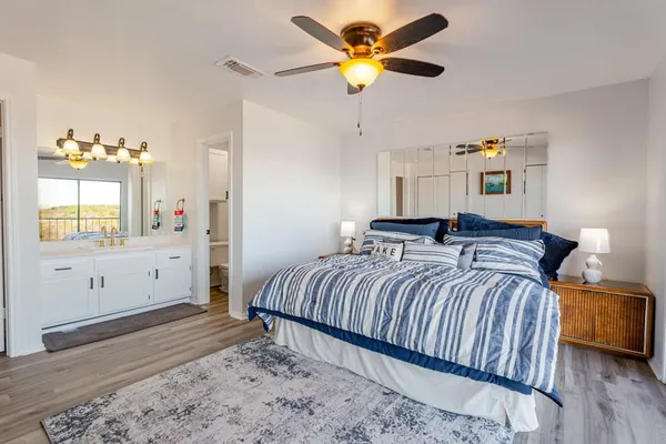 a bedroom with a bed and a chandelier