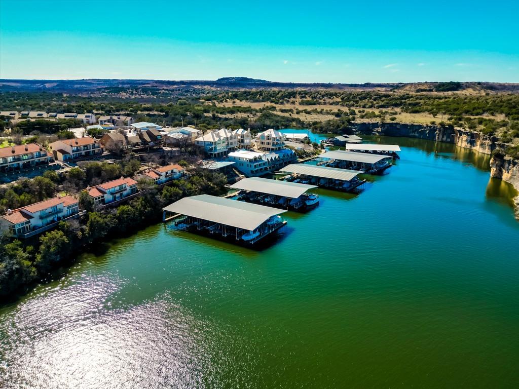 3107 Hells Gate Loop, Unit B62 Strawn, TX 76475 - Photo 7 of 24 a view of a lake with multiple houses