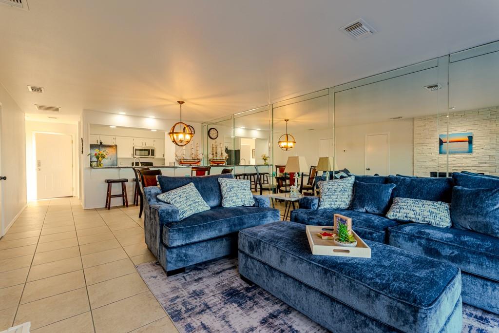 3107 Hells Gate Loop, Unit B62 Strawn, TX 76475 - Photo 9 of 24 a living room with furniture and a chandelier