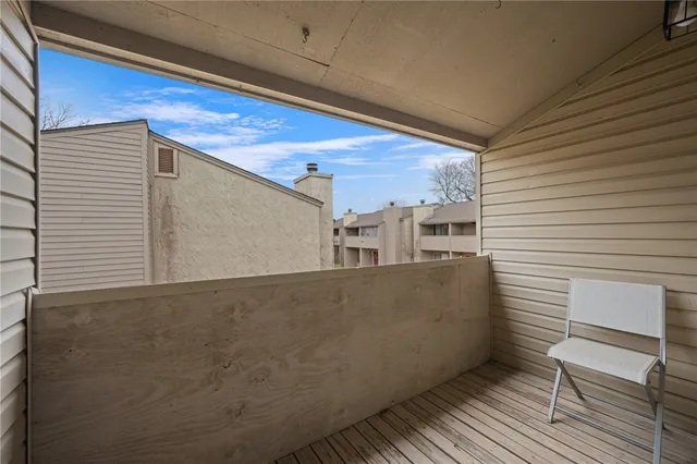 a view of a balcony with wooden floor