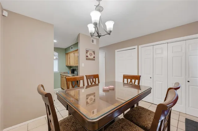 a view of a dining room with furniture and a chandelier