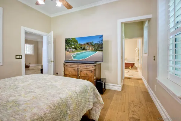 a view of a room with wooden floor and a hallway