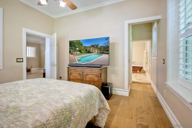 a view of a room with wooden floor and a hallway
