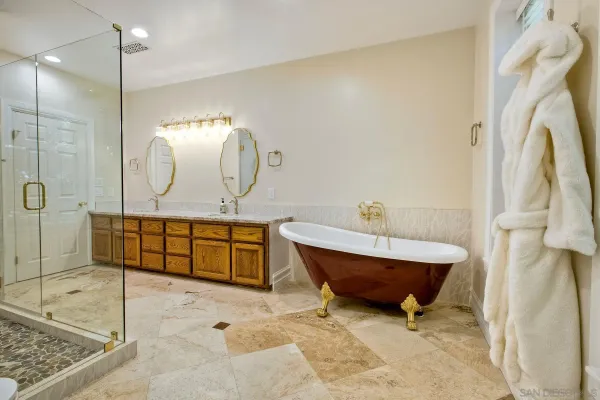 a spacious bathroom with a tub and a large window