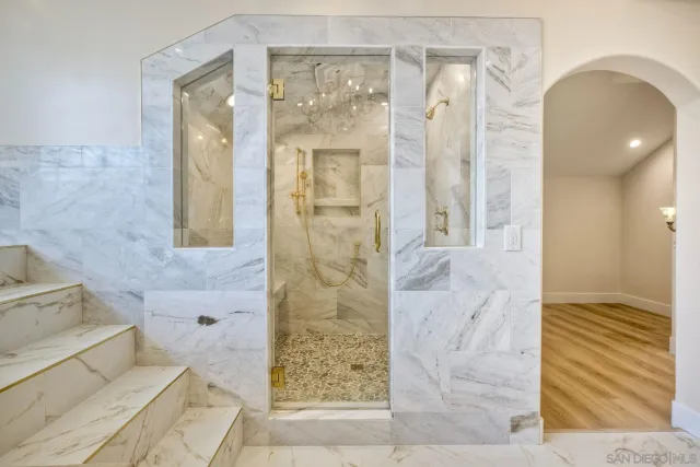 a bed sitting in a spacious bedroom next to a window