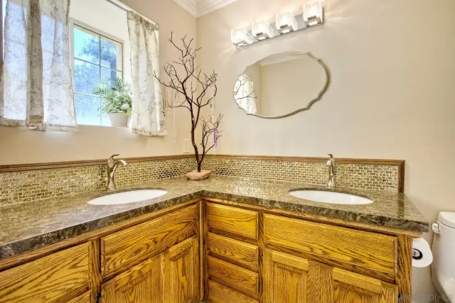 a aerial view of a house with a yard lake and trees all around