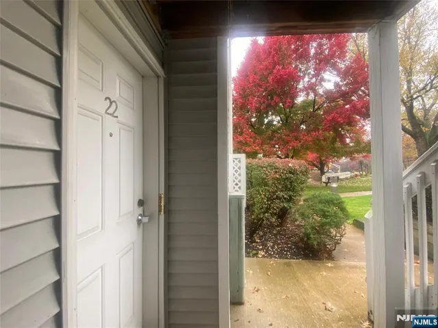 a view of a glass door with a yard from a window
