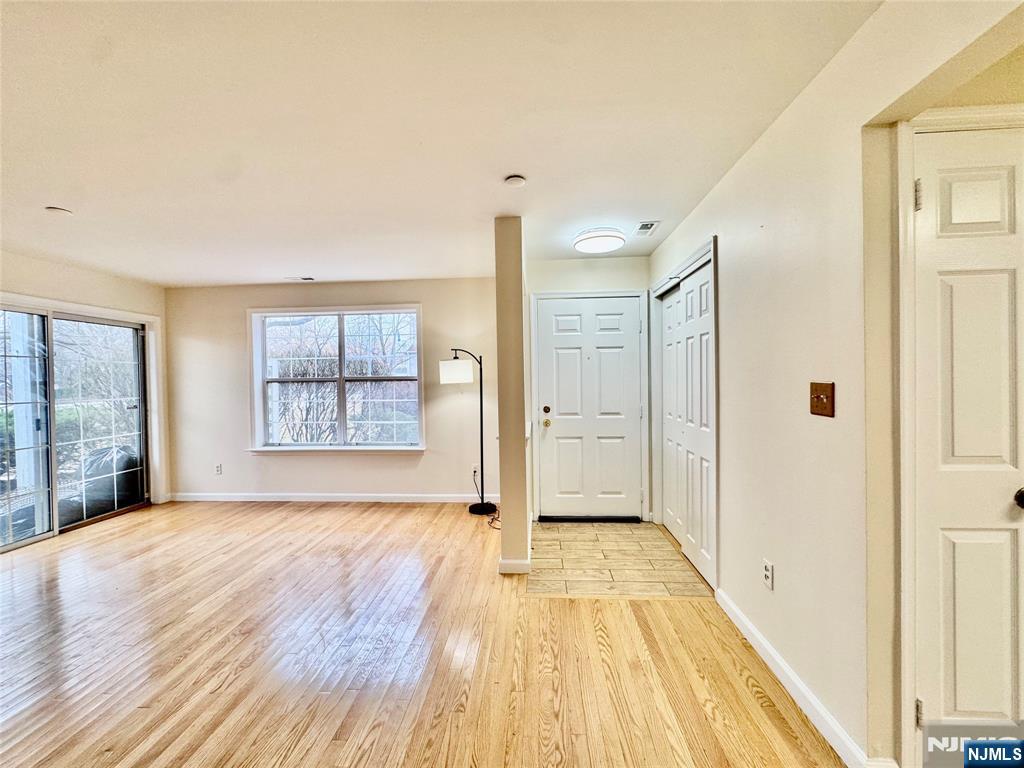 22 Regency Circle Englewood, NJ 07631 - Photo 4 of 21 a view of a livingroom with wooden floor and a window