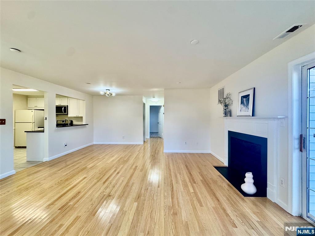 22 Regency Circle Englewood, NJ 07631 - Photo 5 of 21 a view of a bedroom with a bed and wooden floor