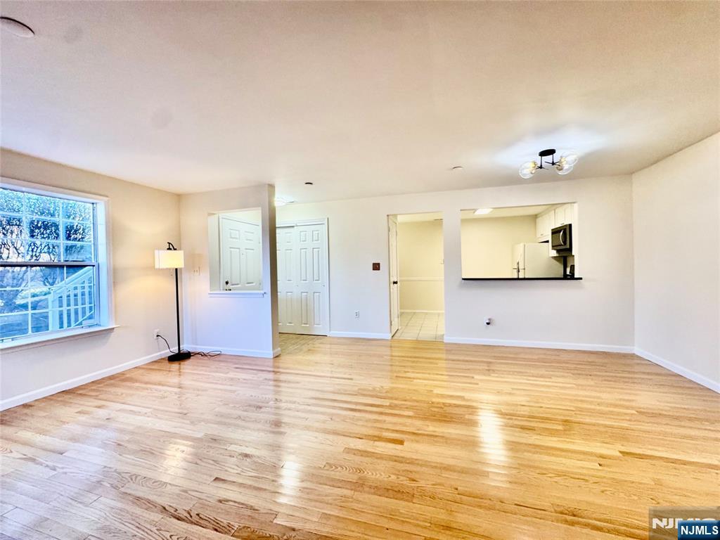22 Regency Circle Englewood, NJ 07631 - Photo 6 of 21 a view of empty room with wooden floor and windows