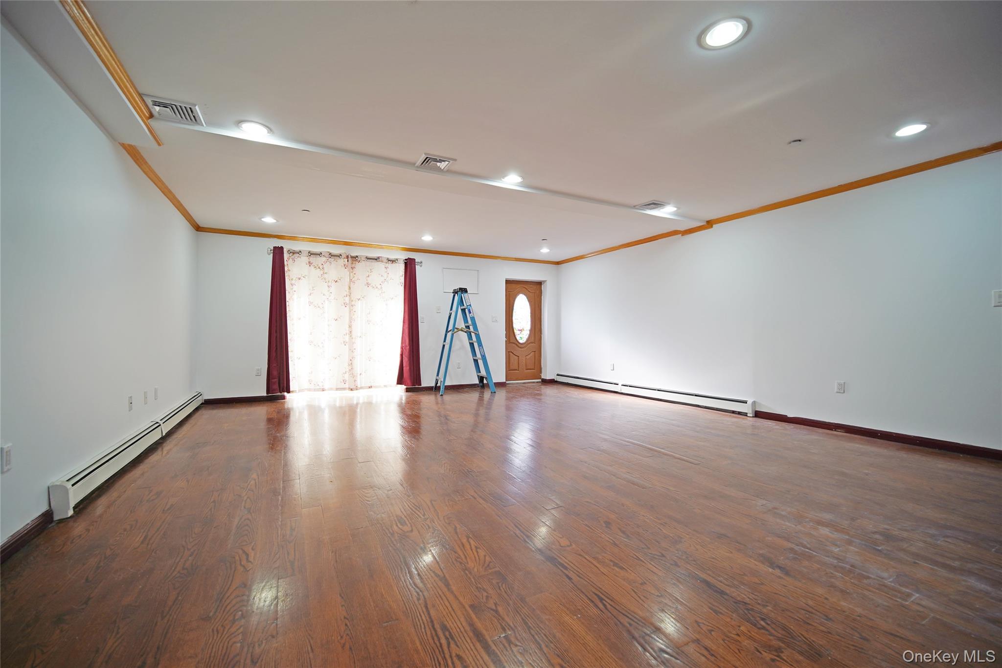 931 East 215th Street, Unit 2 Bronx, NY 10469 - Photo 15 of 16 a view of empty room with wooden floor