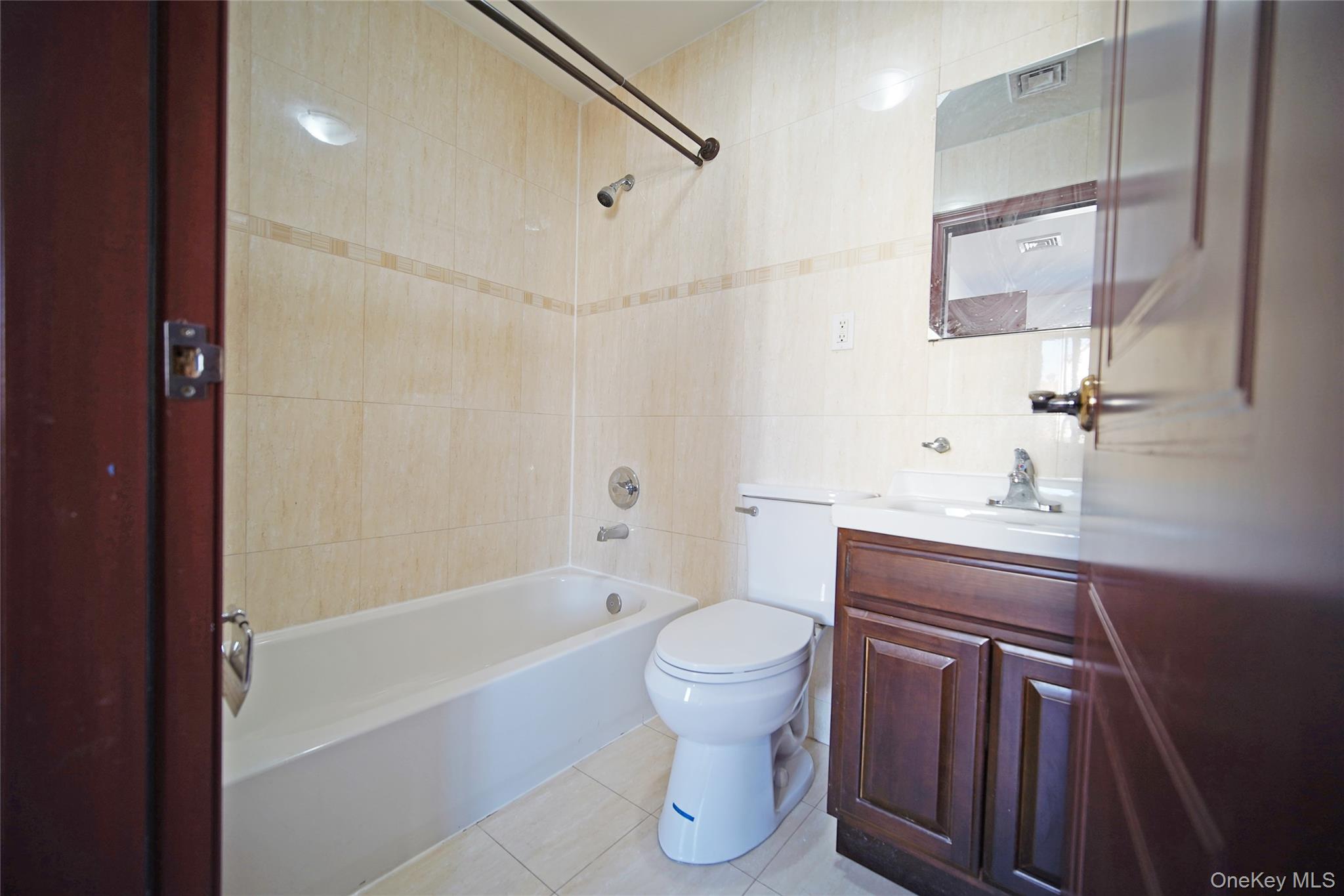 931 East 215th Street, Unit 2 Bronx, NY 10469 - Photo 8 of 16 a bathroom with a sink toilet and shower
