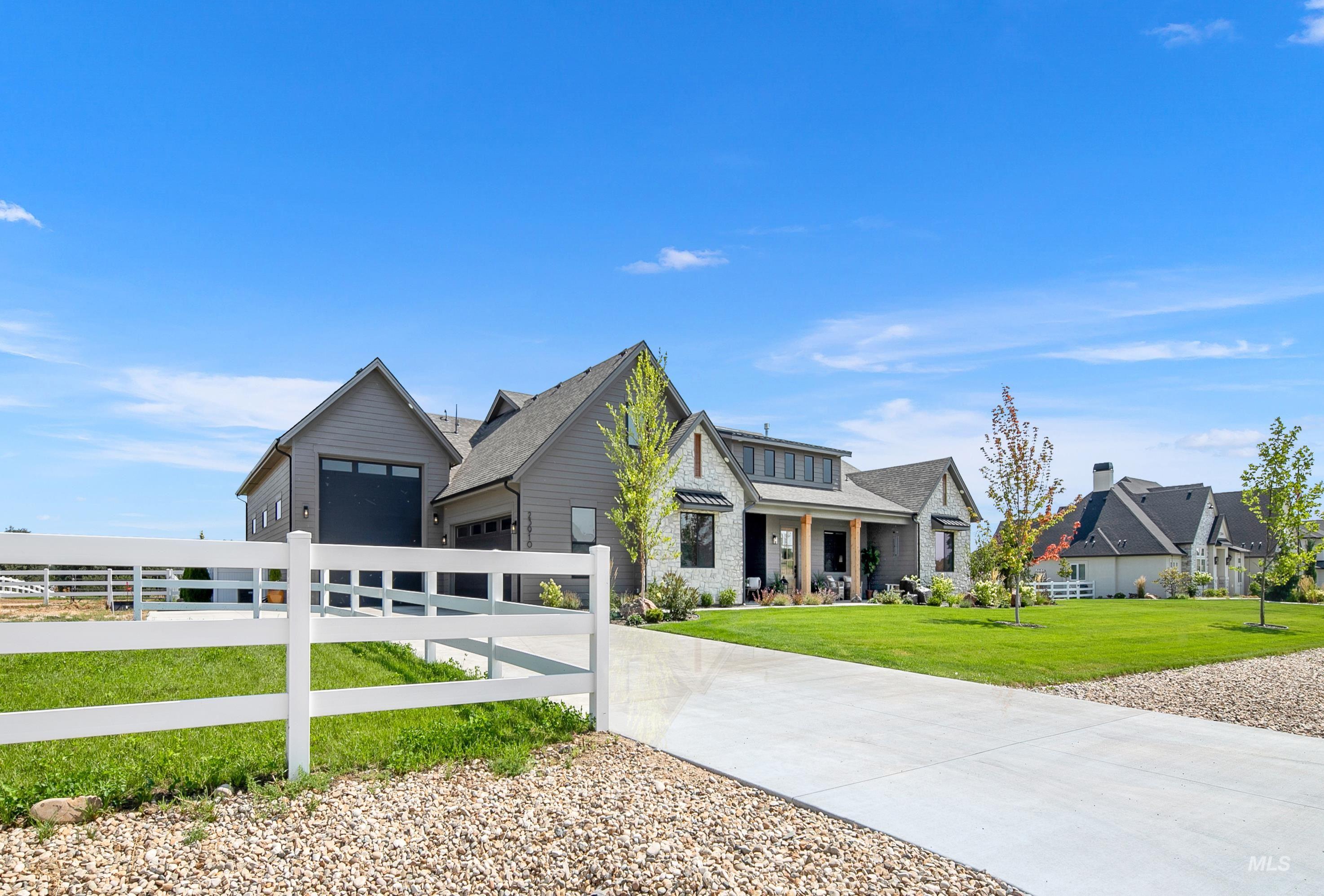 23910 Timber Hls Road Caldwell, ID 83607 - Photo 1 of 50 View of front of house featuring a garage, driveway, and covered porch