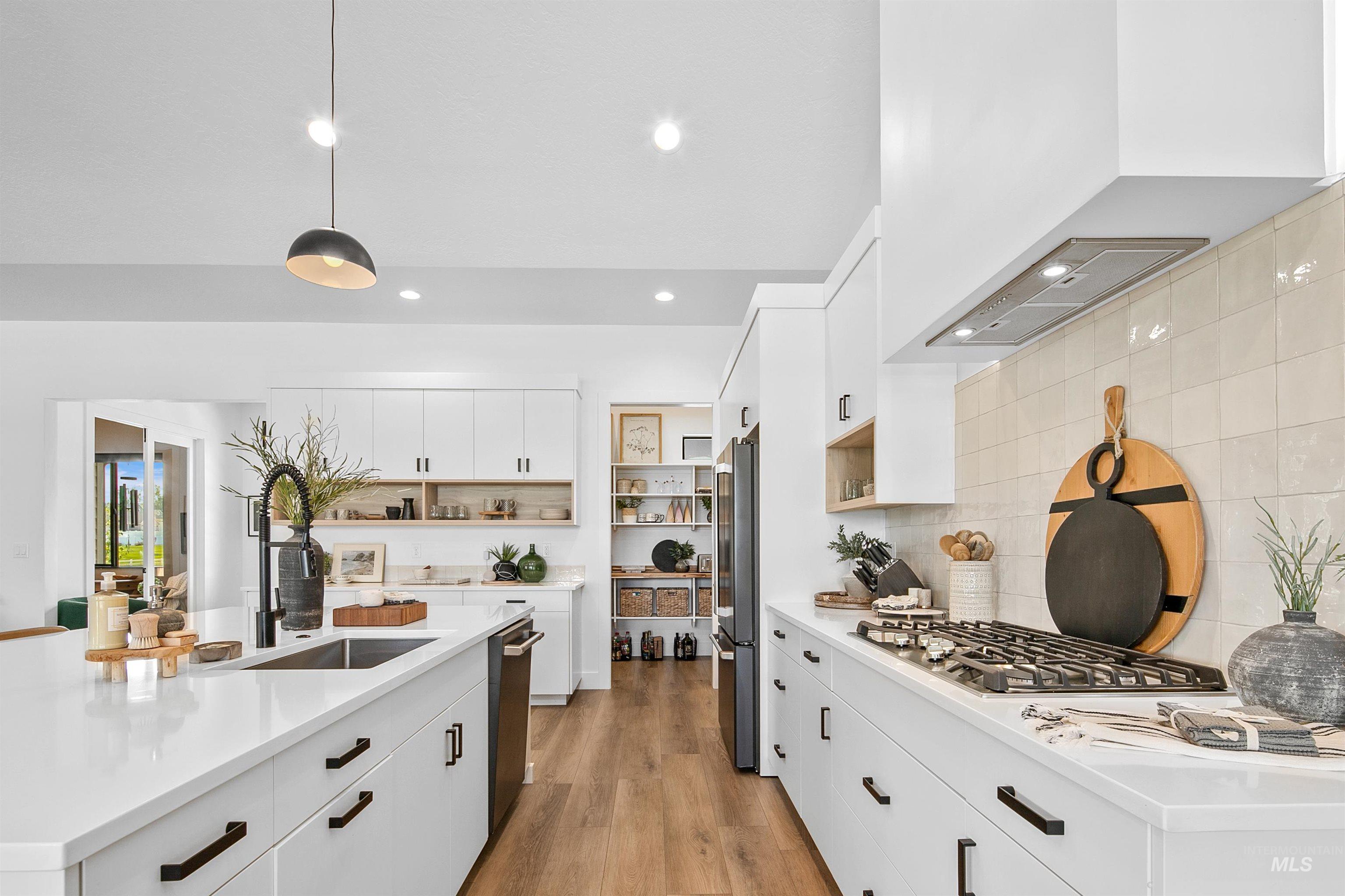 23910 Timber Hls Road Caldwell, ID 83607 - Photo 14 of 50 Kitchen featuring white cabinetry, open shelves, pendant lighting, light wood-style floors, and recessed lighting