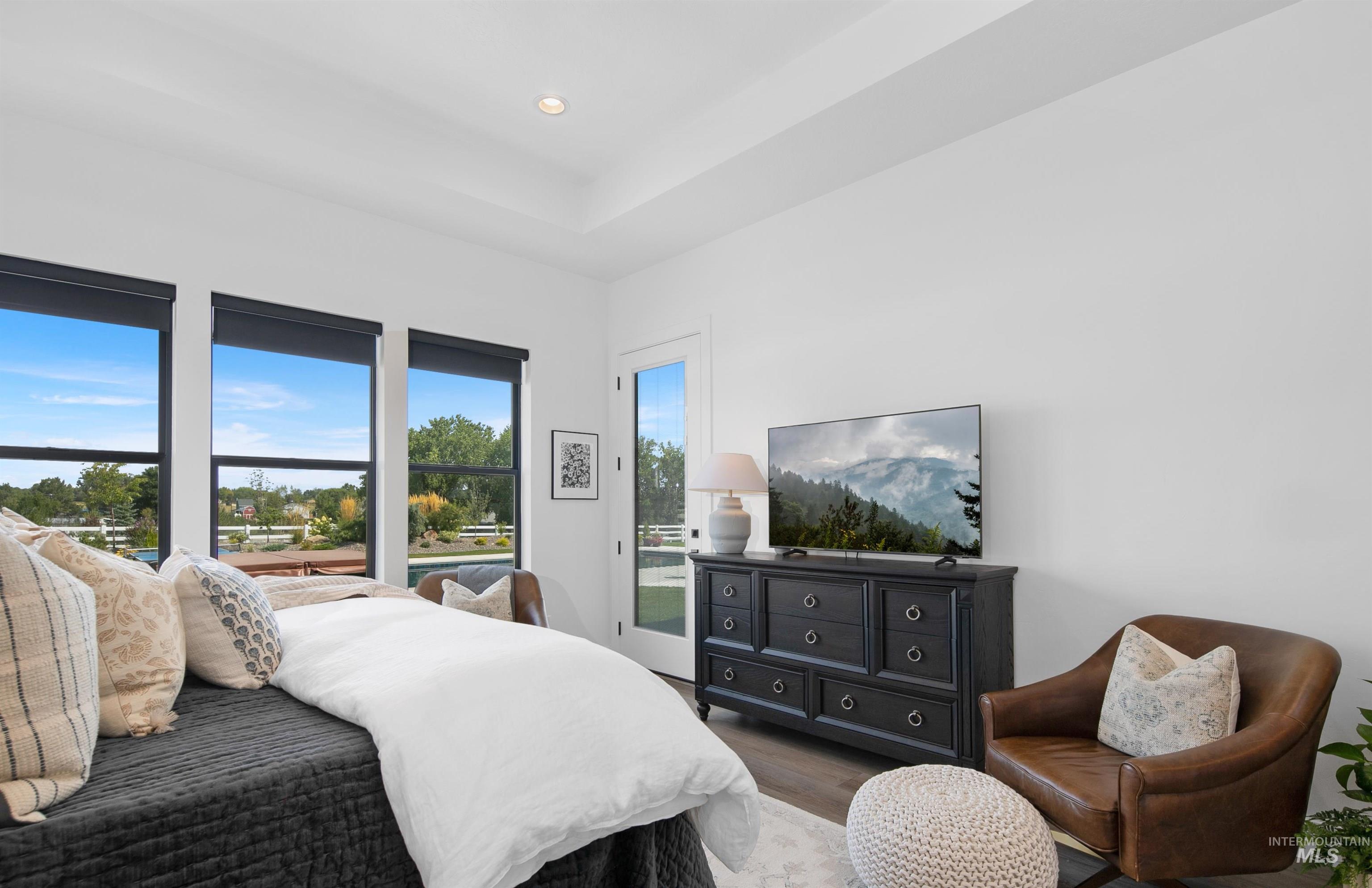 23910 Timber Hls Road Caldwell, ID 83607 - Photo 23 of 50 Bedroom with wood finished floors, recessed lighting, and a tray ceiling