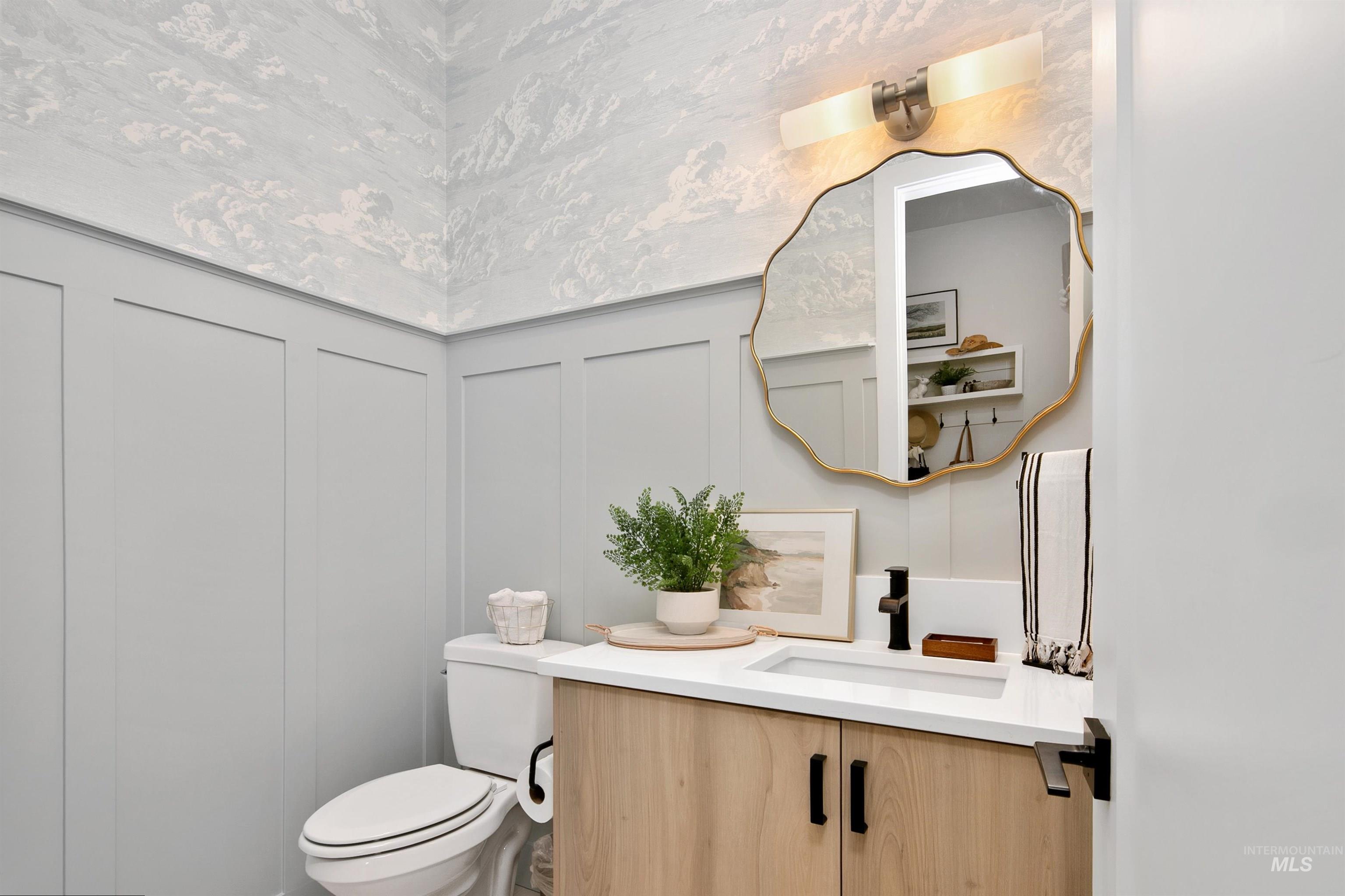 23910 Timber Hls Road Caldwell, ID 83607 - Photo 27 of 50 Bathroom featuring a decorative wall, vanity, and wainscoting