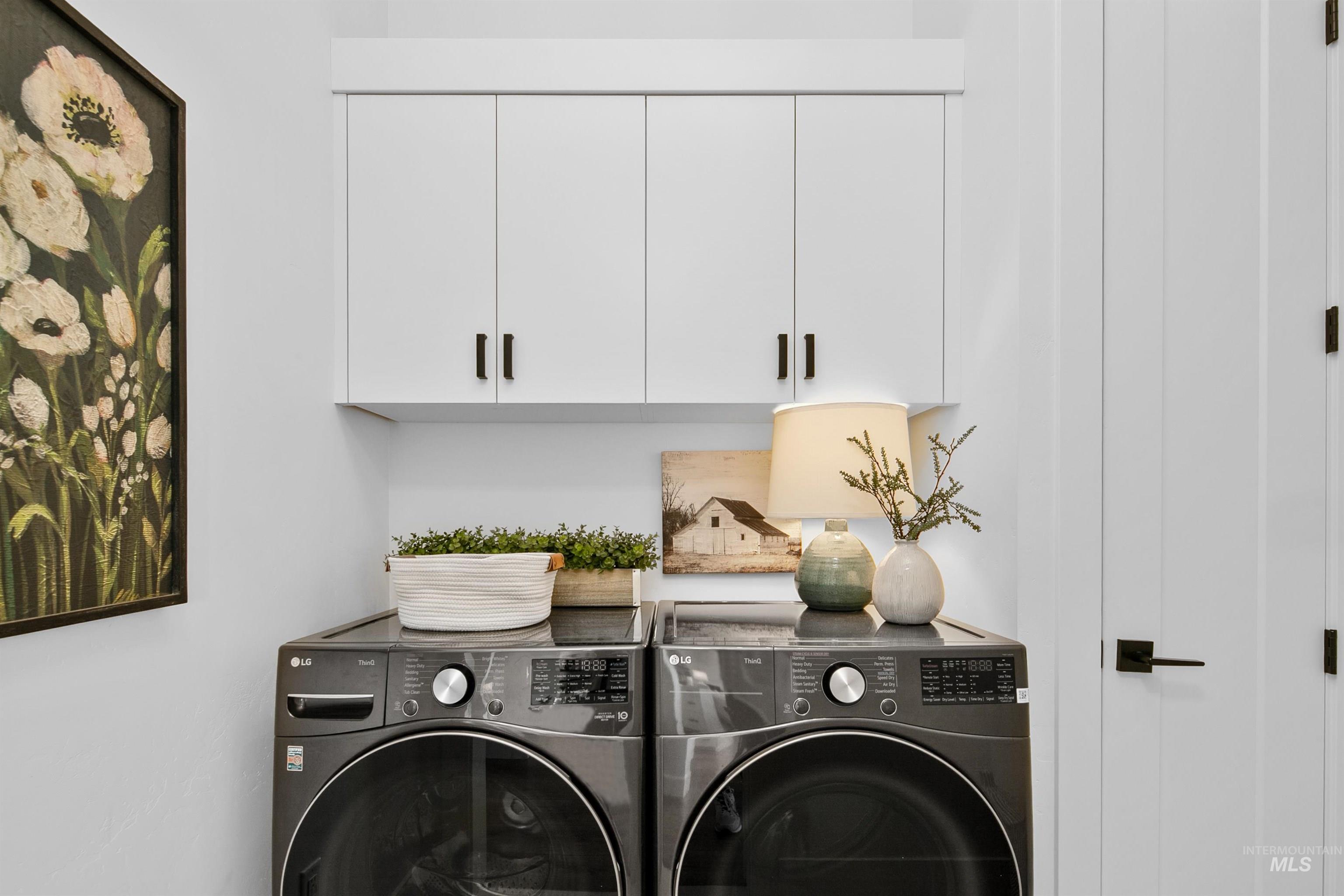 23910 Timber Hls Road Caldwell, ID 83607 - Photo 38 of 50 Laundry room with cabinet space and separate washer and dryer