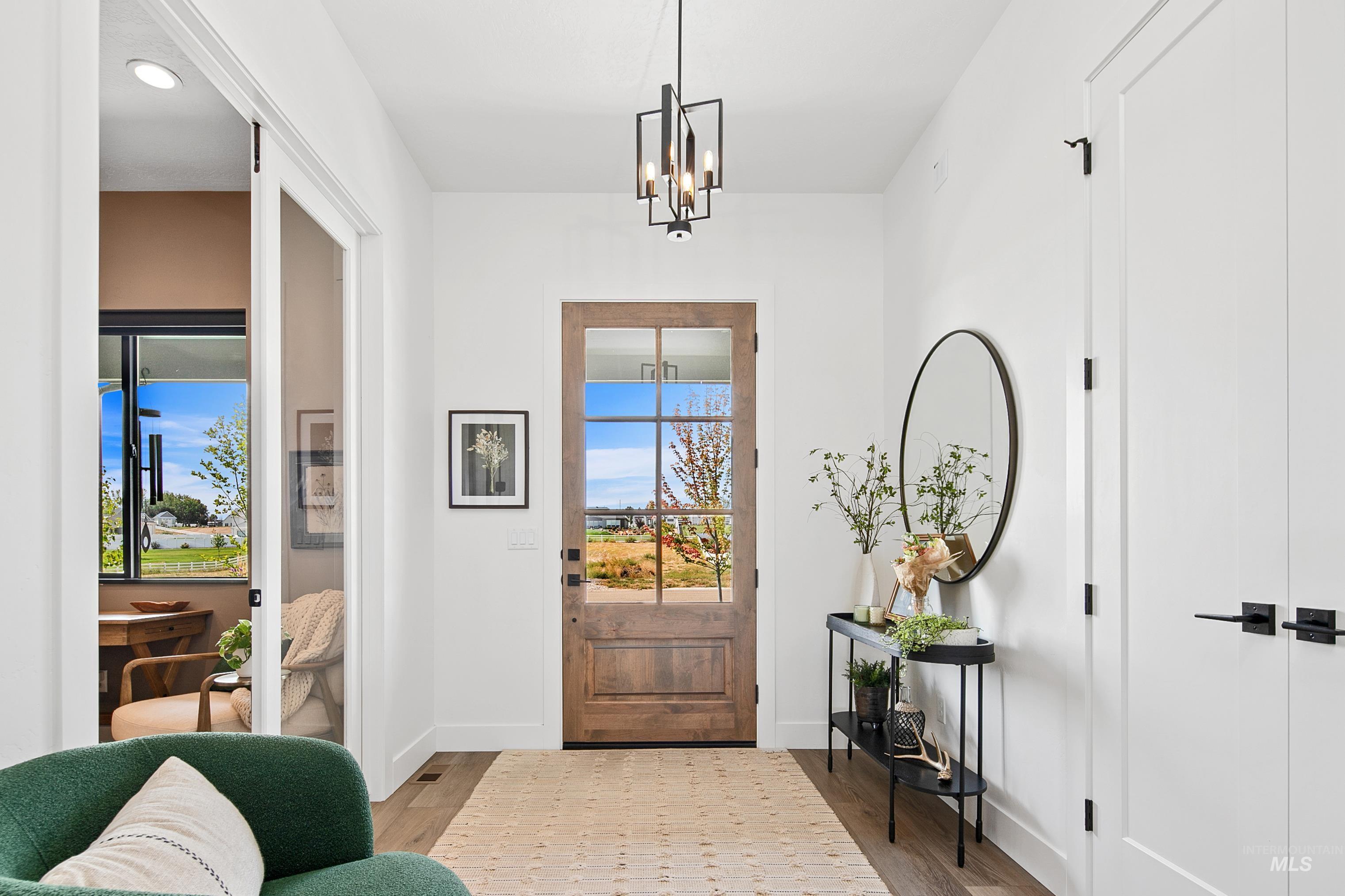 23910 Timber Hls Road Caldwell, ID 83607 - Photo 6 of 50 Entryway featuring wood finished floors, a chandelier, and recessed lighting